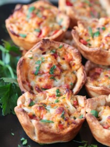 crab puffs on black platter with parsley