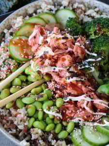 salmon rice bowl with chopsticks in the middle