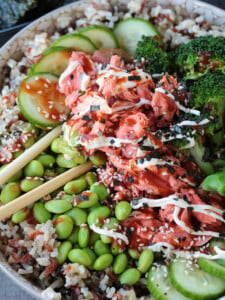 salmon rice bowl with chopsticks in the middle