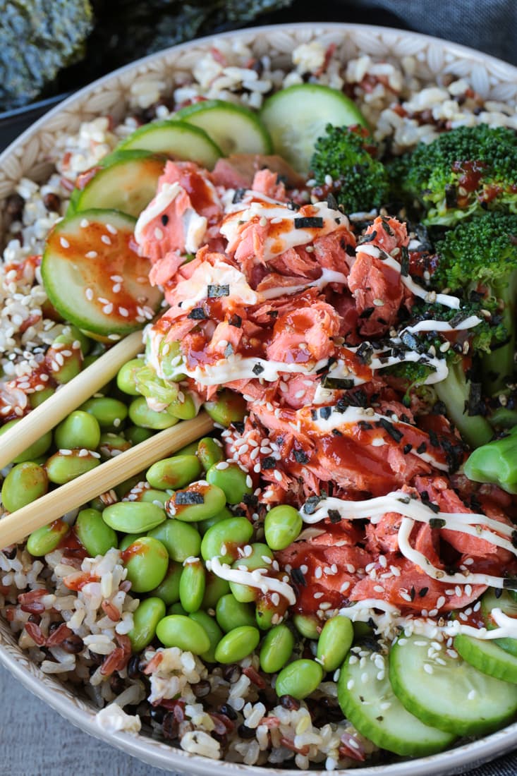 salmon rice bowl with chopsticks in the middle