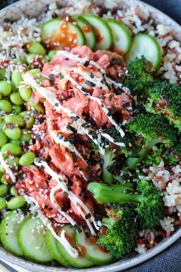 salmon and vegetables in a bowl with sriracha mayonnaise