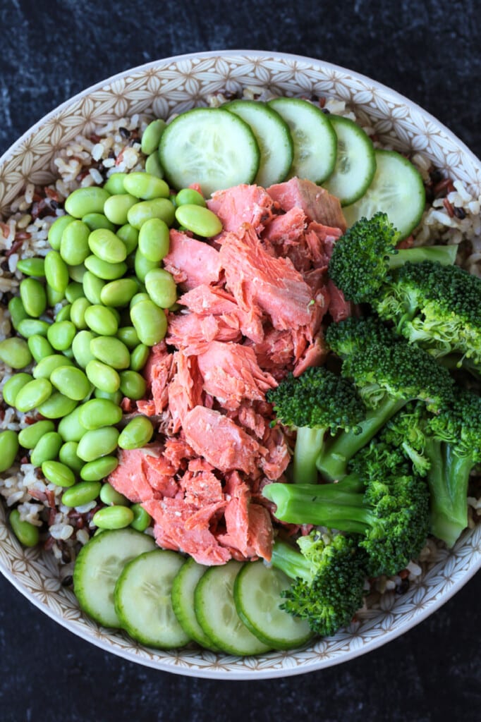vegetables and salmon in a bowl with rice