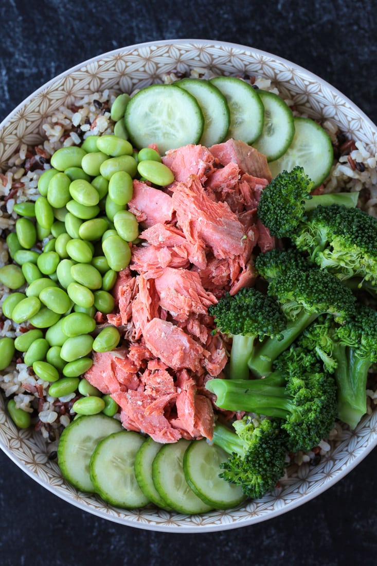 vegetables and salmon in a bowl with rice