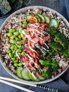 salmon rice bowl with chopsticks on the side