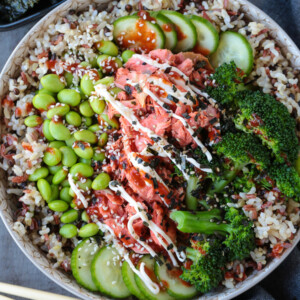 salmon rice bowl with chopsticks on the side