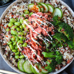 salmon rice bowl with chopsticks on the side