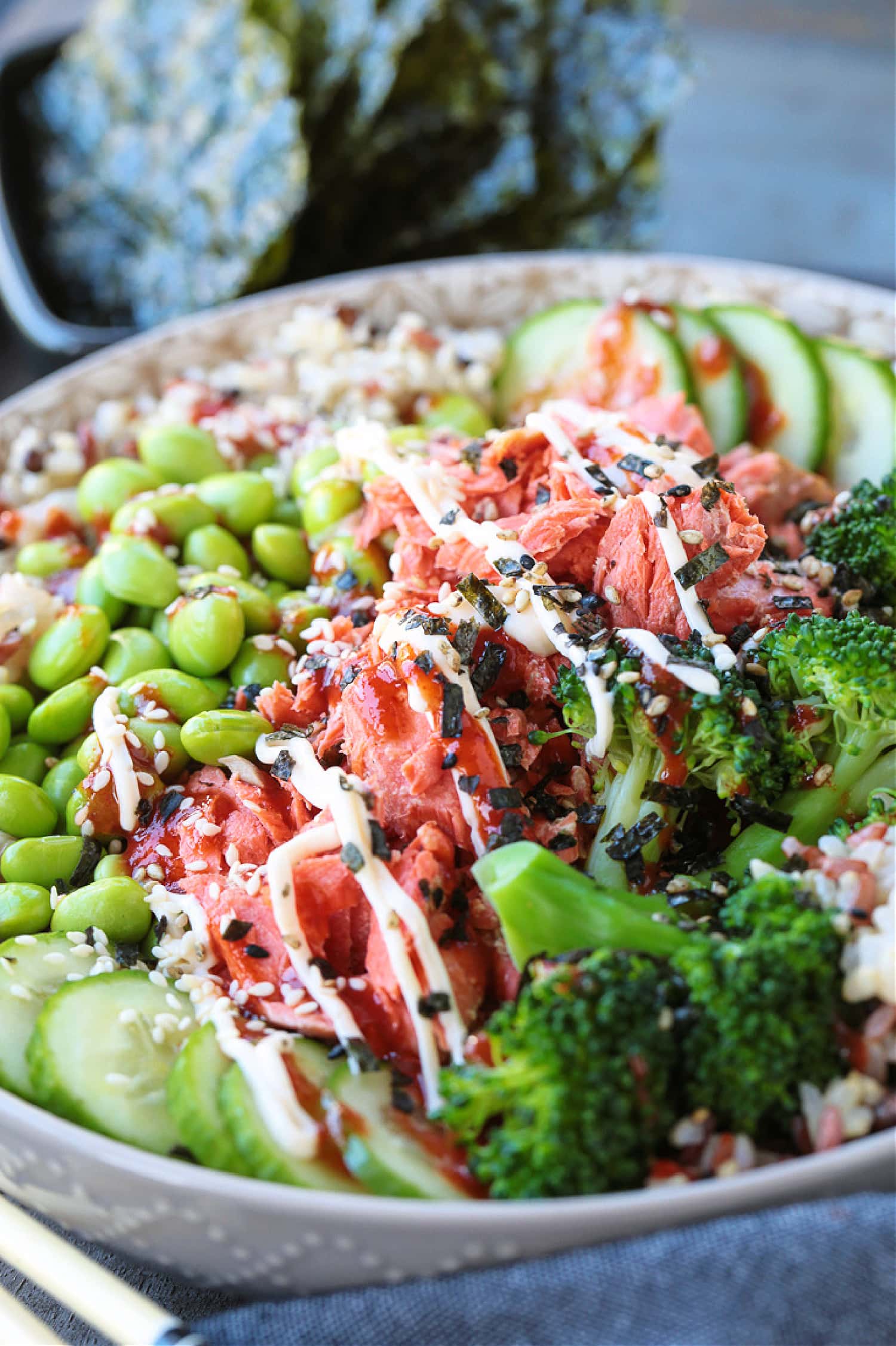 salmon rice bowl with sriracha mayo drizzle on top