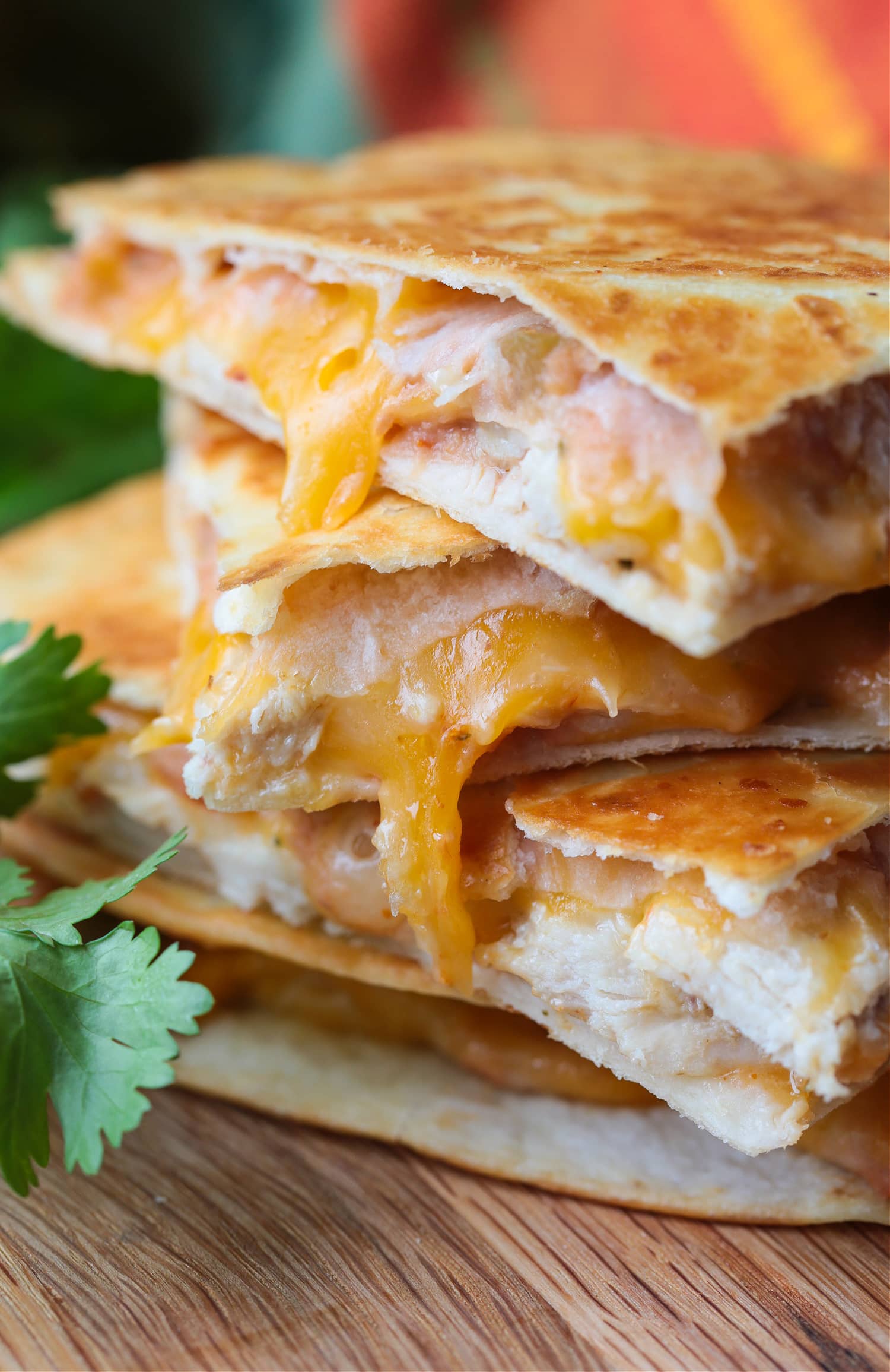 chicken quesadillas stacked on a board