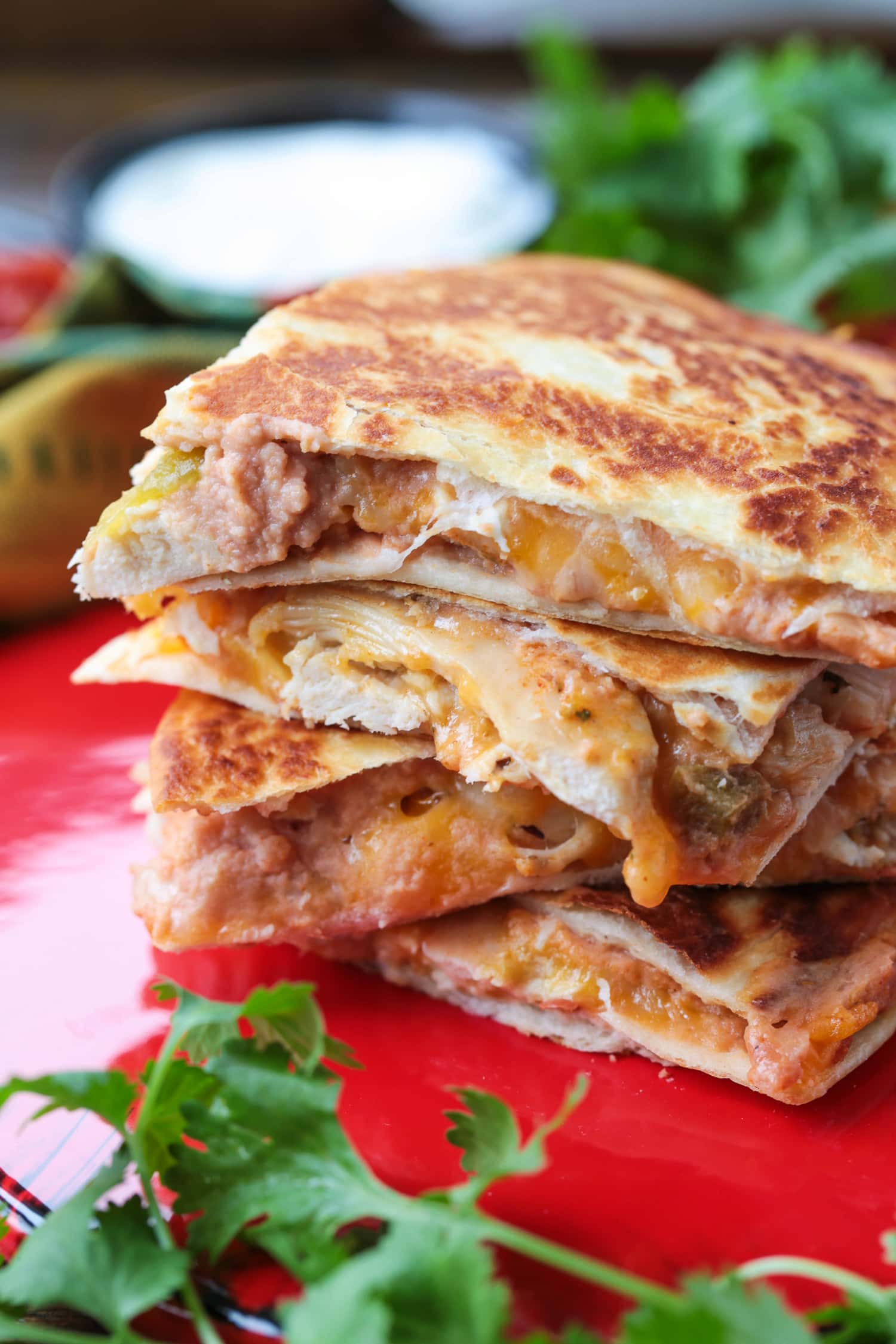 chicken quesadillas stacked on a red plate