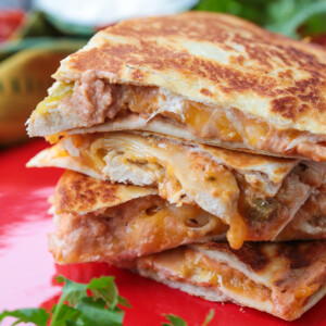Four chicken quesadilla triangles stacked on top of each other