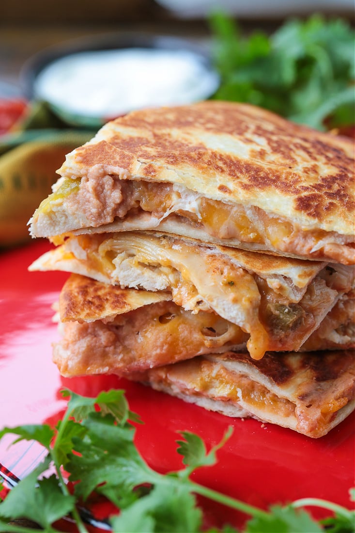 Four chicken quesadilla triangles stacked on top of each other