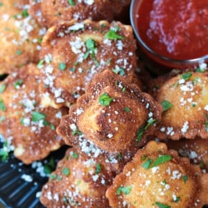 fried ravioli on plate with marinara sauce for dipping