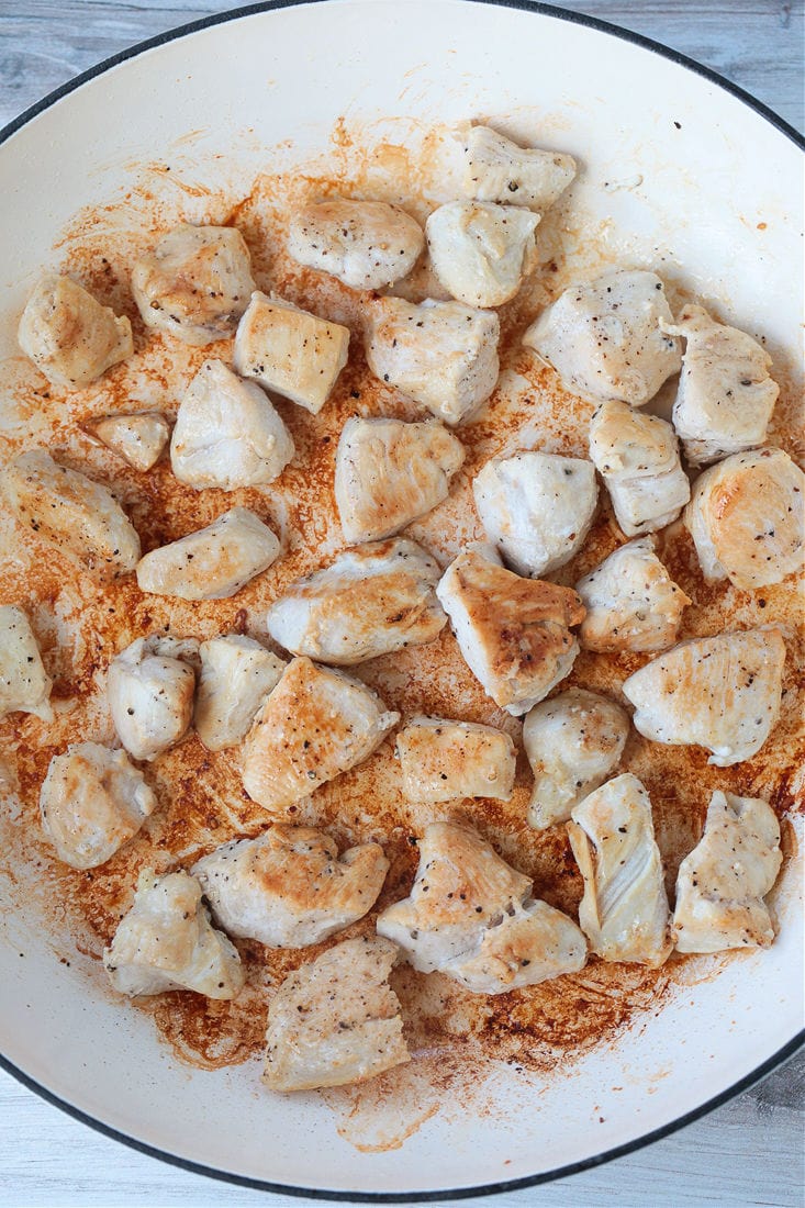 Cubes of cooked chicken breast in a pot