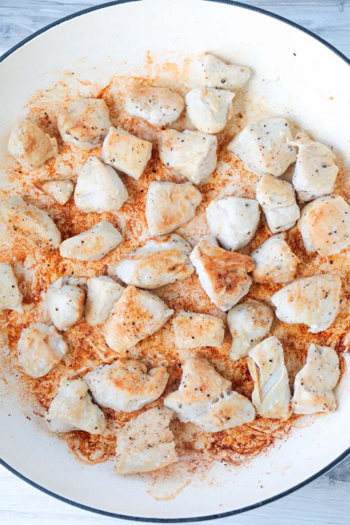 browned, diced chicken in a skillet