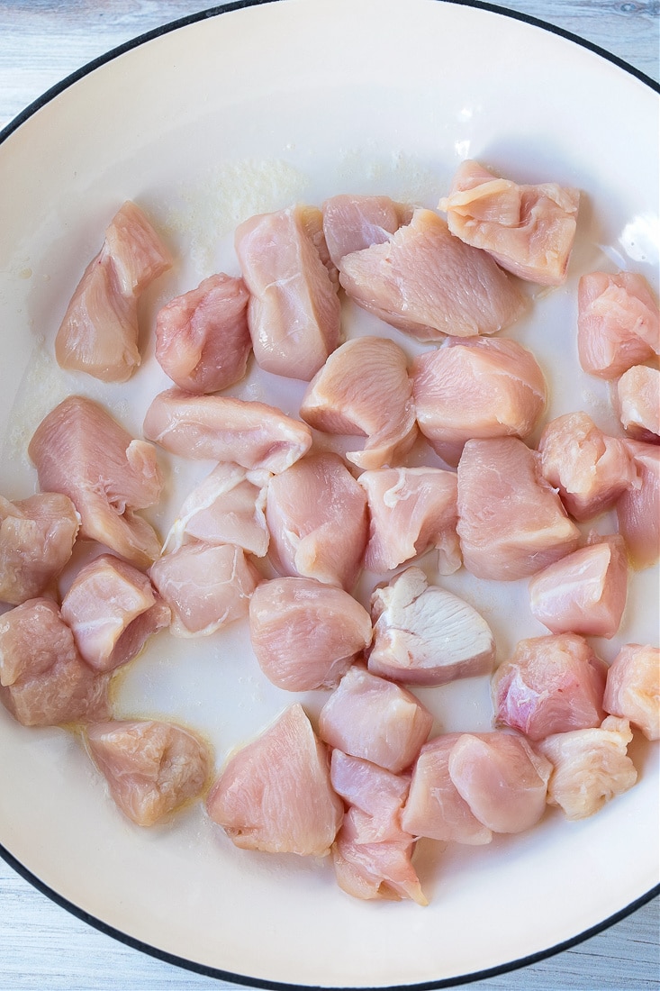 Cubes of raw chicken breast in a pot