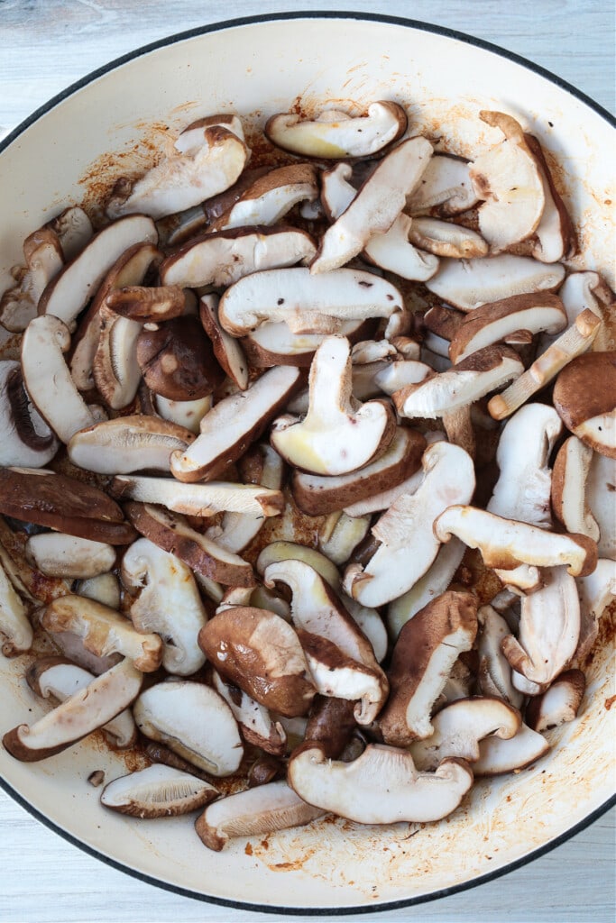 uncooked, sliced mushrooms in a skillet