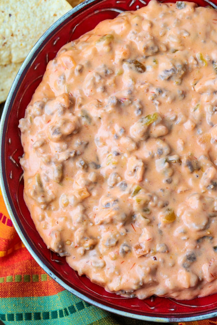 sausage cheese dip in bowl with chips on the side