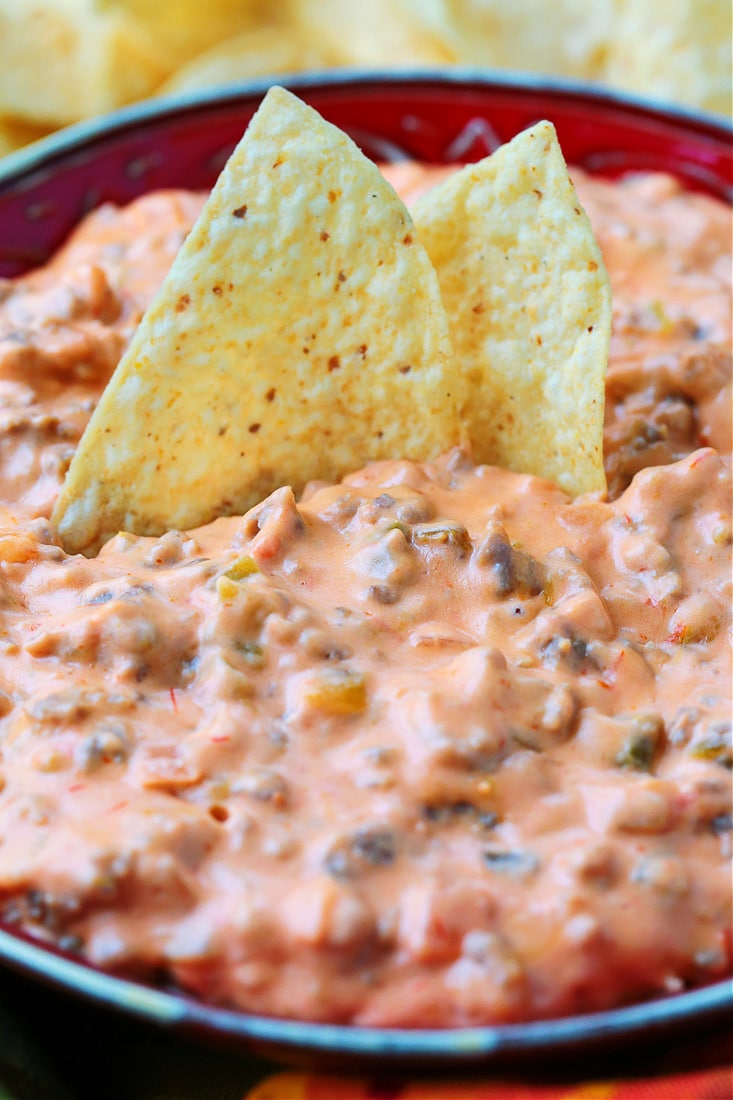 sausage cheese dip with chips dipped in