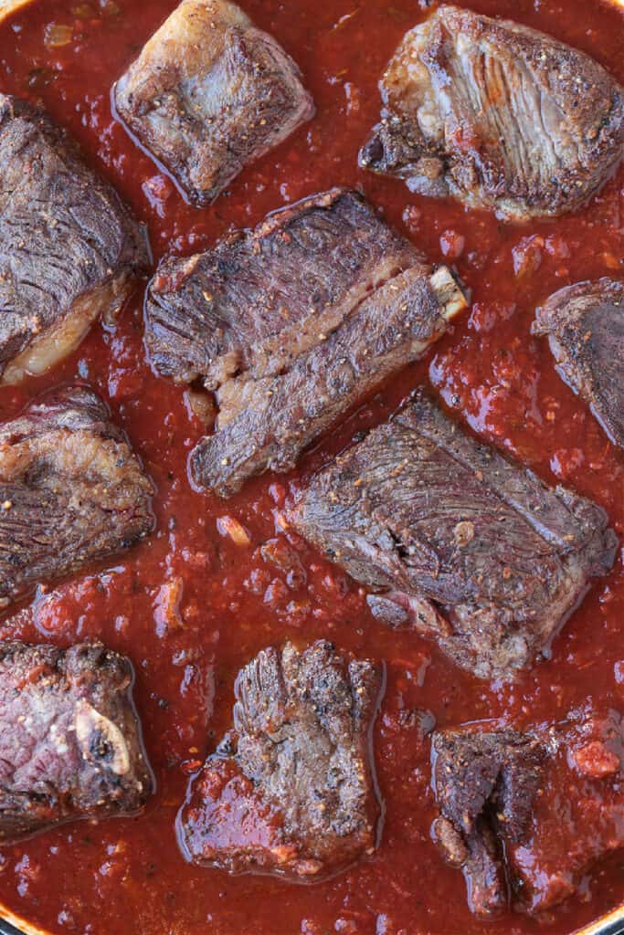 short ribs tucked into tomato sauce