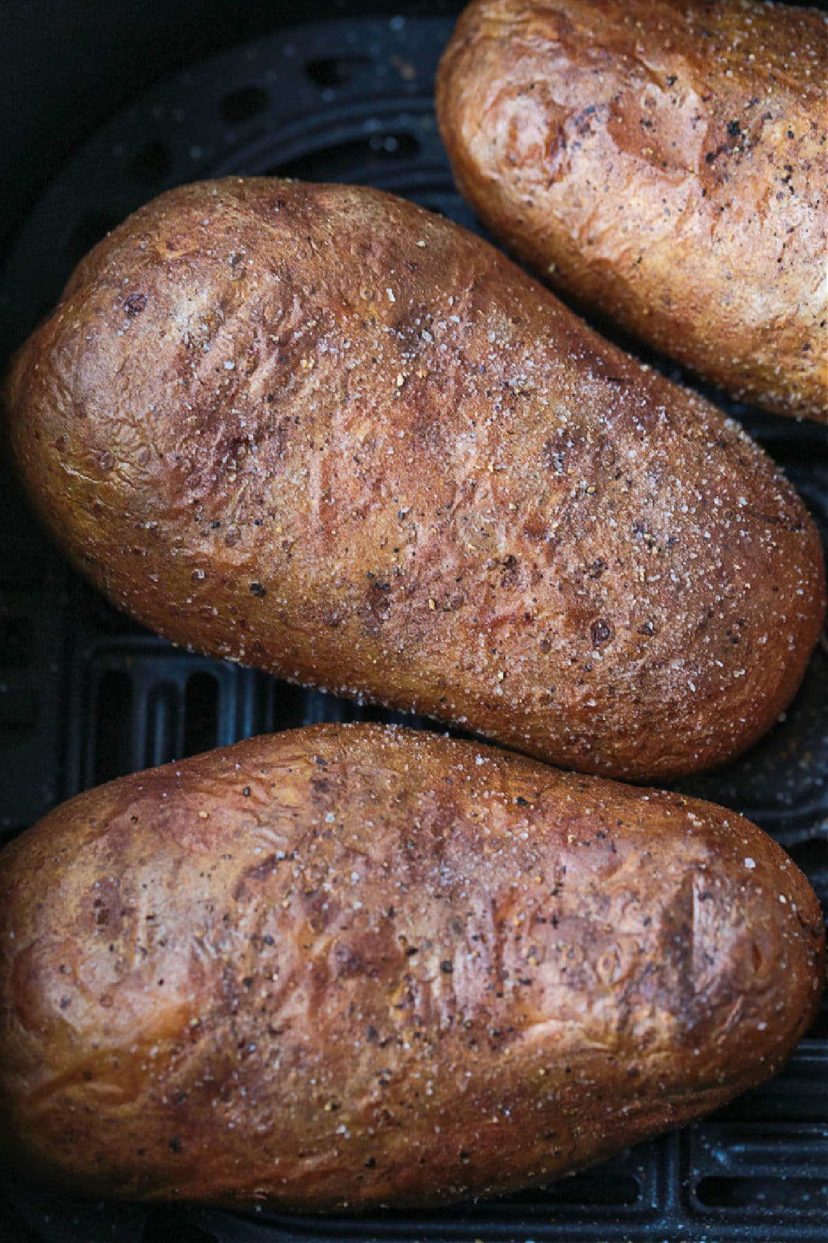 These fluffy Air Fryer Baked Potatoes have the most crispy skin! Free up the oven and let the air fryer do the work for you! baked potatoes in an air fryer