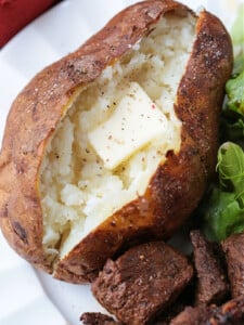 baked potato on plate with butter