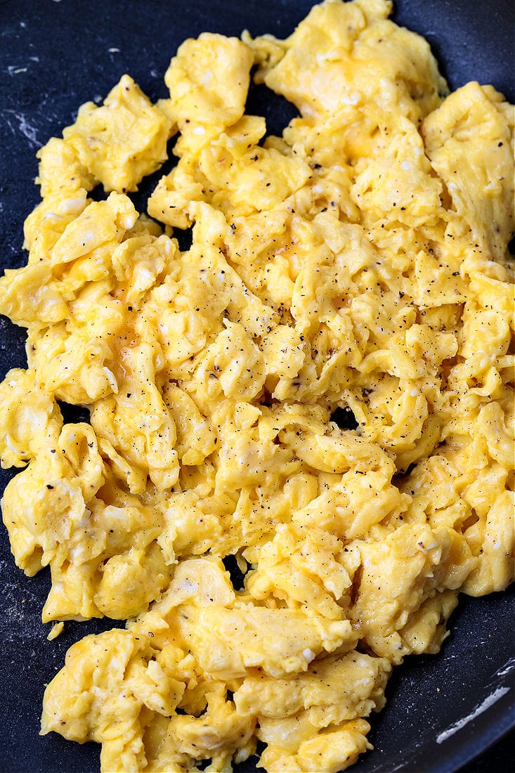 Breakfast Baked Potatoes are stuffed with fluffy scrambled eggs, cheese and crispy bacon! So fun for brunch, breakfast and even dinner! scrambled eggs in skillet