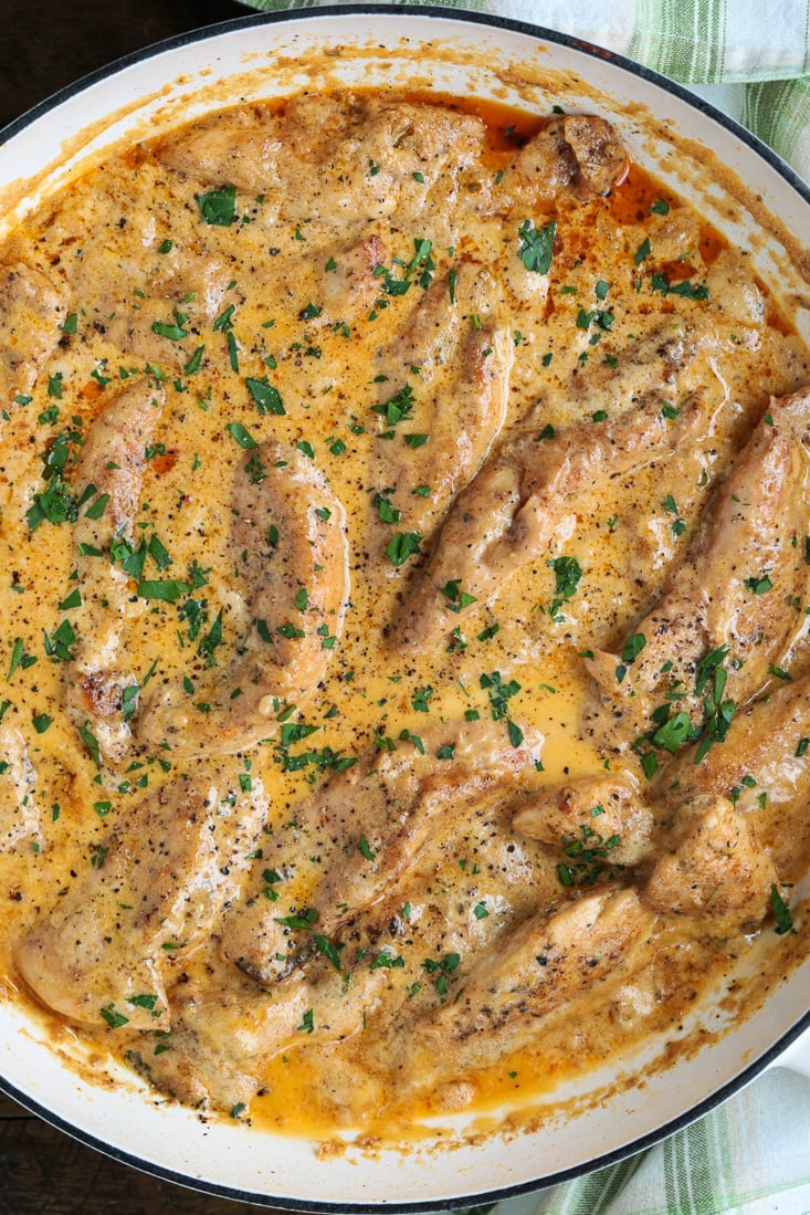 chicken tenderloins in cream sauce in a skillet