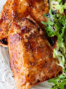 glazed salmon filets on a plate with salad