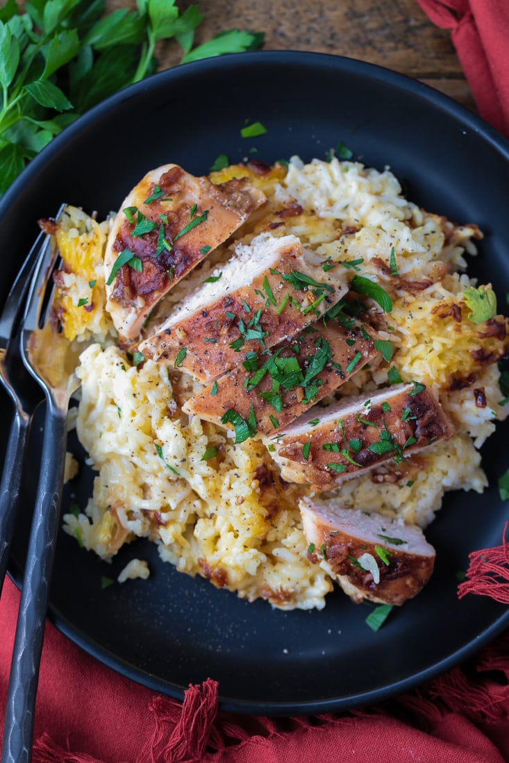 sliced chicken on a plate of rice with napkin