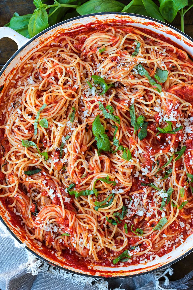 pasta pomodoro in a pot with fresh basil