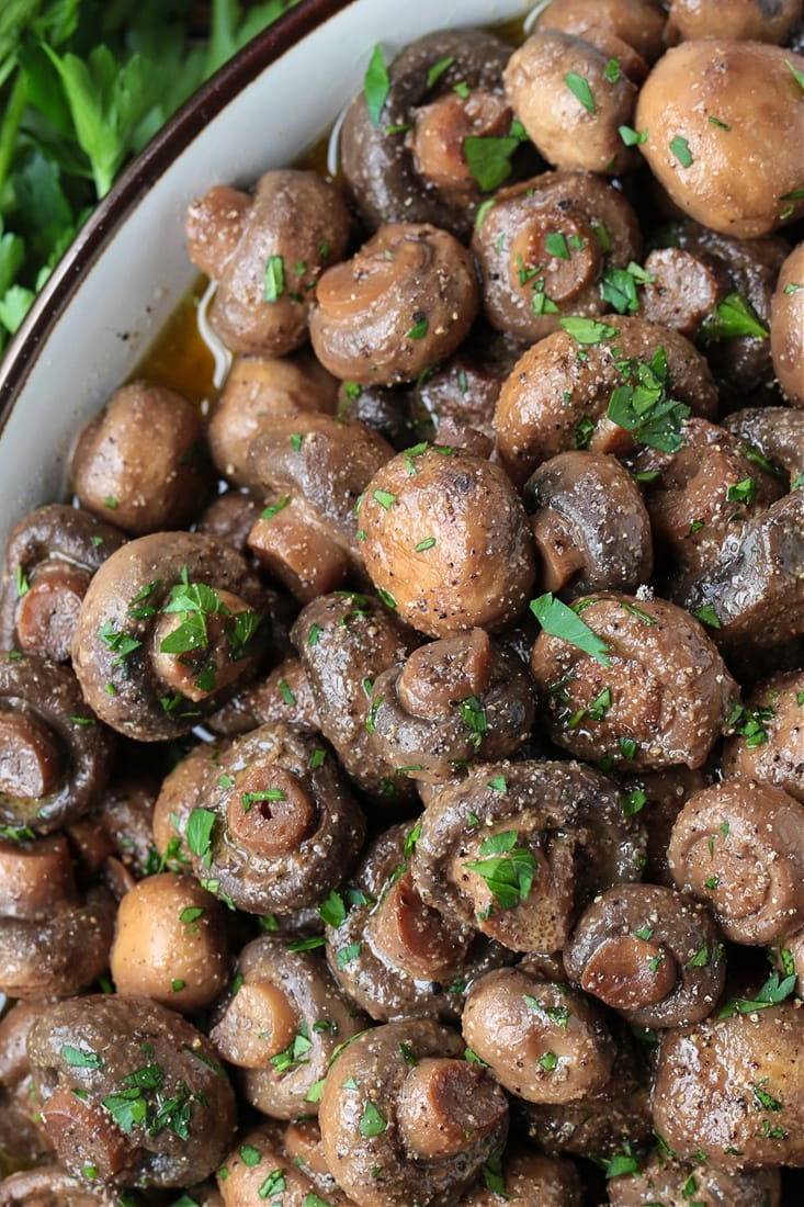 mushrooms cooked in wine and butter in serving dish