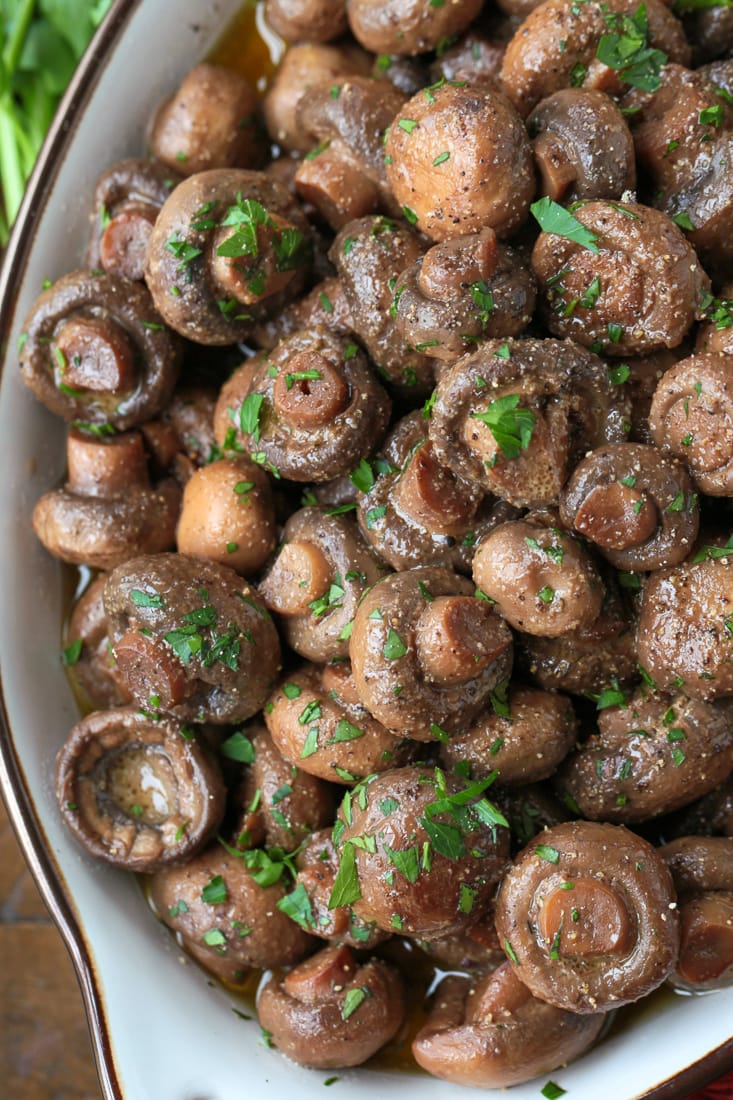 mushrooms in a serving dish with parsley for garnish