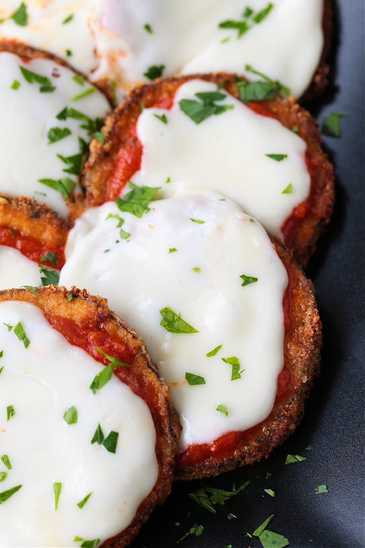 fried eggplant topped with sauce and cheese