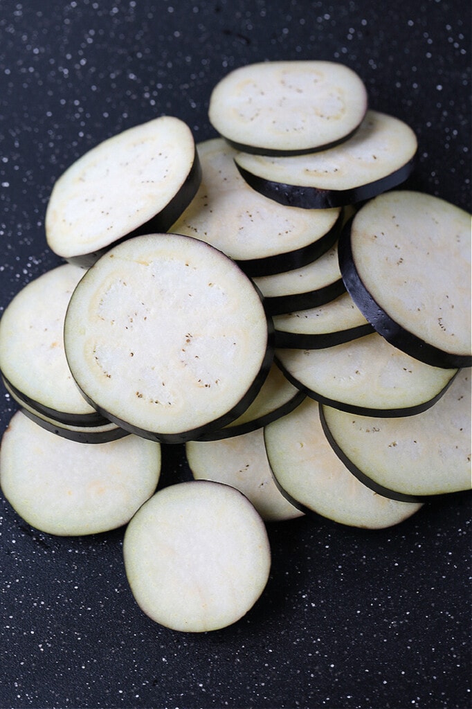 sliced eggplant stacked on board