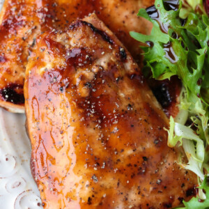 glazed salmon filets on a plate with salad