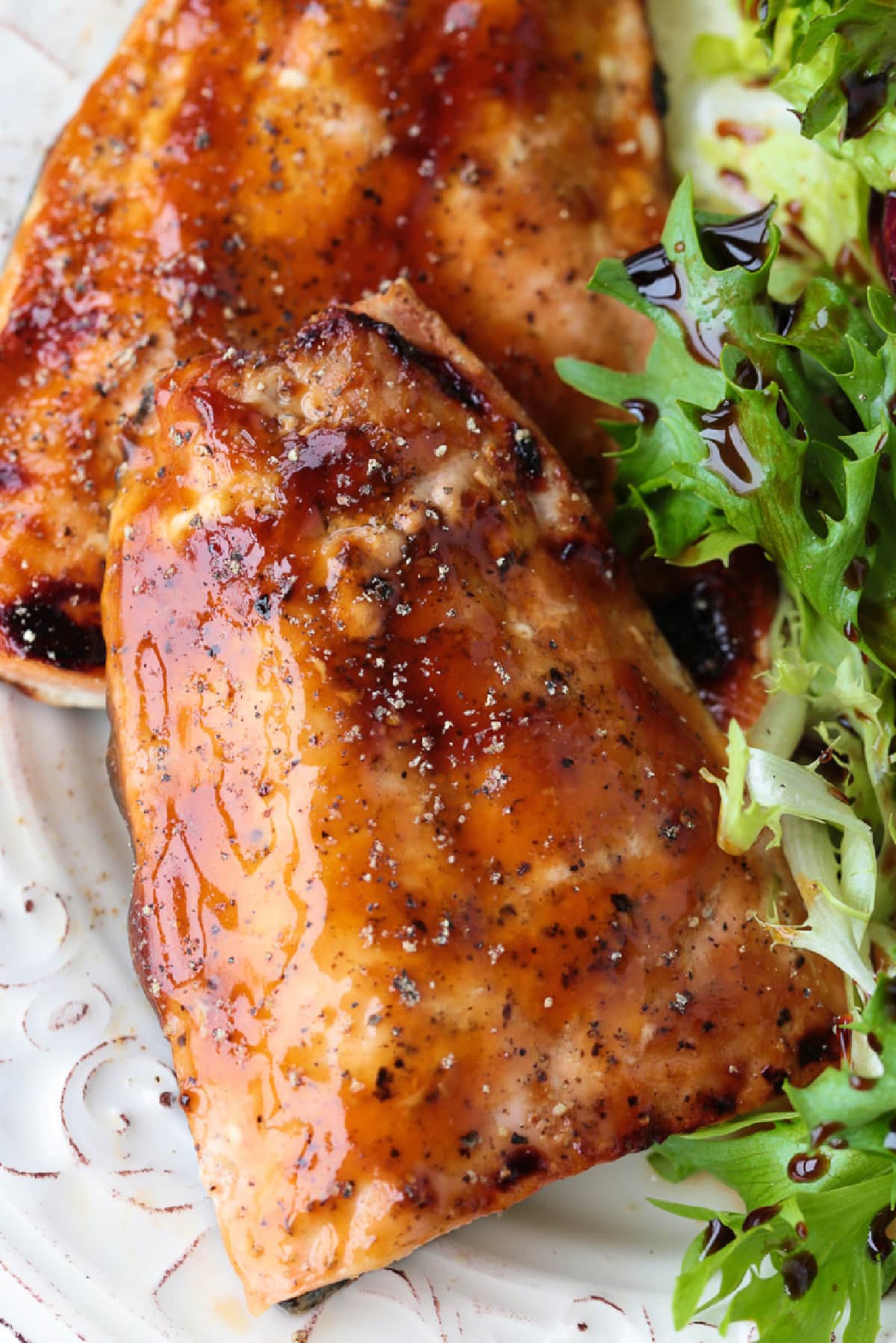 glazed salmon filets on a plate with salad