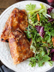 teriyaki glazed salmon on a plate with salad