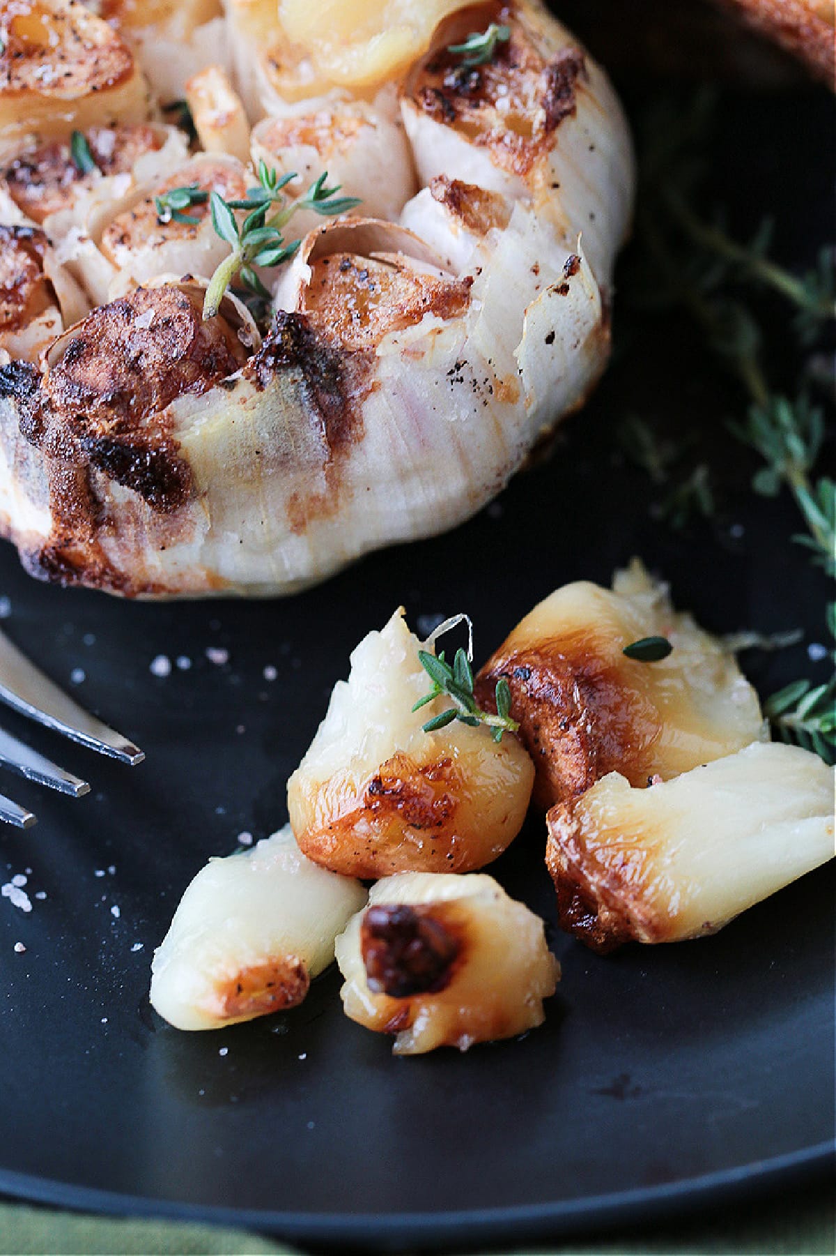 Air Fryer Roasted Garlic is done in half the time! Creamy, nutty roasted garlic that can be used as a spread or in many different recipes! air fryer roasted garlic bulbs squeezed out