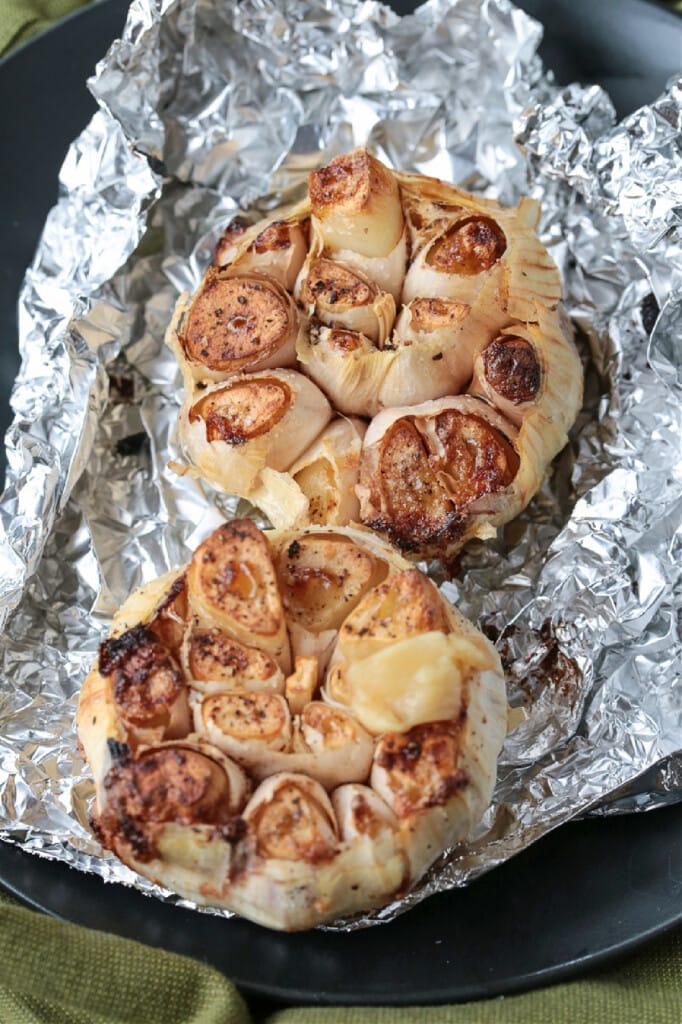 Air Fryer Roasted Garlic is done in half the time! Creamy, nutty roasted garlic that can be used as a spread or in many different recipes! air fryer roasted garlic in foil