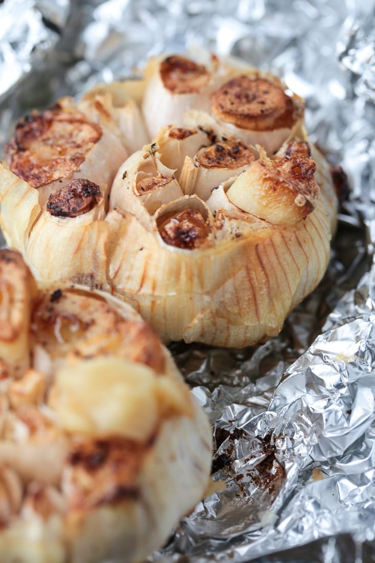 Air Fryer Roasted Garlic is done in half the time! Creamy, nutty roasted garlic that can be used as a spread or in many different recipes!
