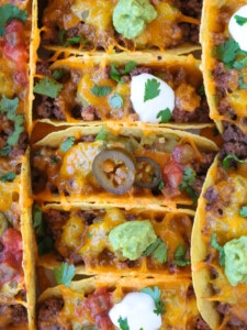 baked tacos in baking dish with toppings