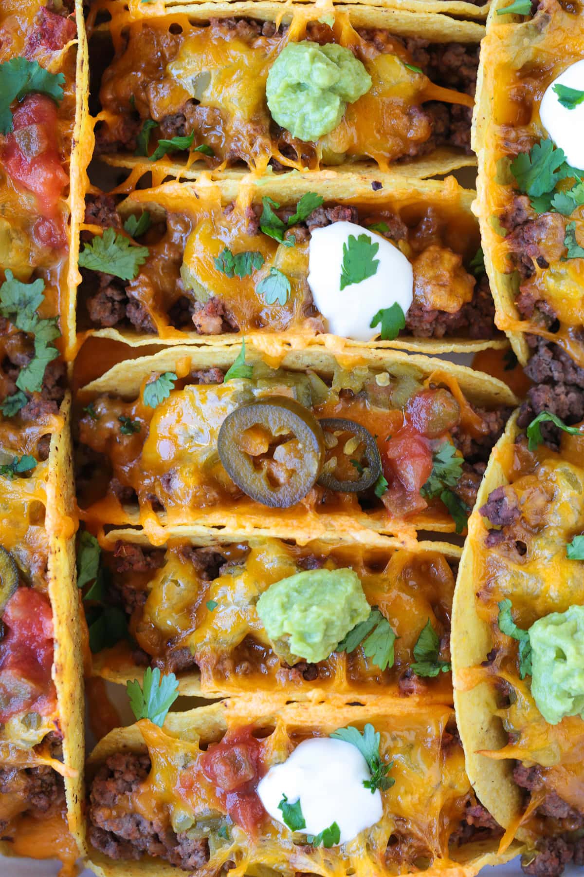 Kick up taco night with these addicting, crispy Baked Tacos! Super easy to make for parties or every day dinners, and everyone loves them! baked tacos with toppings