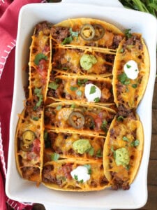 baked tacos in a white baking dish