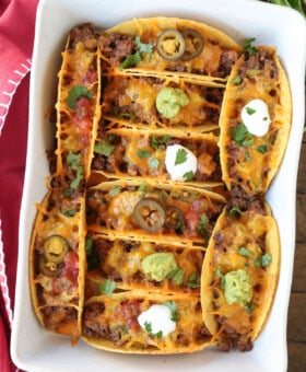 baked tacos in a white baking dish