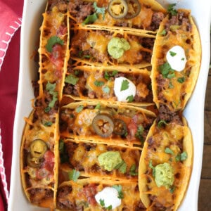 baked tacos in a white baking dish