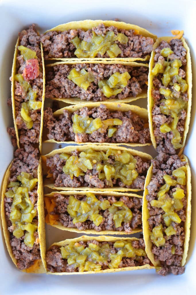 Kick up taco night with these addicting, crispy Baked Tacos! Super easy to make for parties or every day dinners, and everyone loves them! ground beef and green chiles in taco shells