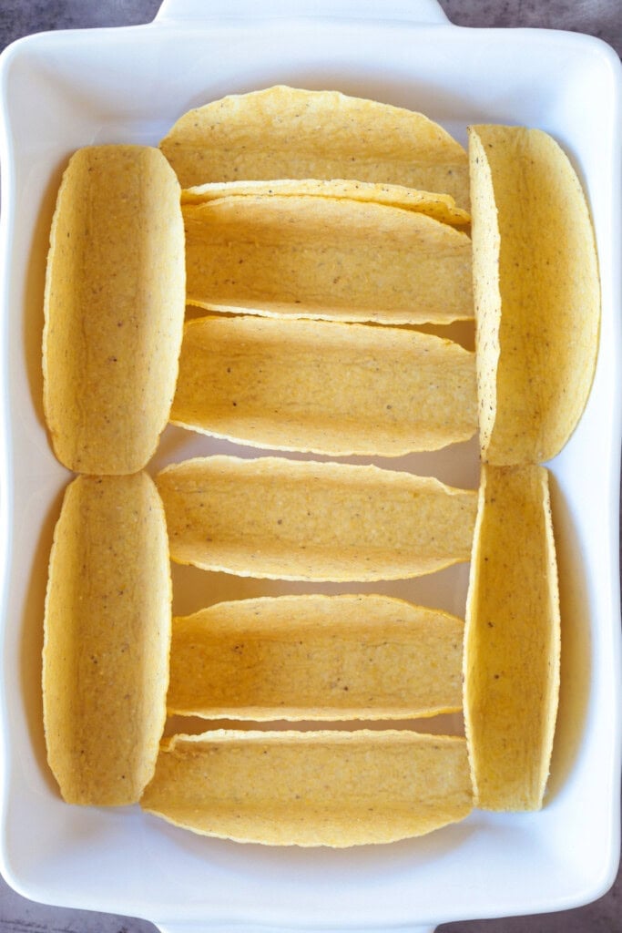 Kick up taco night with these addicting, crispy Baked Tacos! Super easy to make for parties or every day dinners, and everyone loves them! plain taco shells in baking dish
