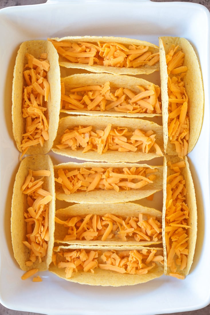 taco shell in baking dish with cheese