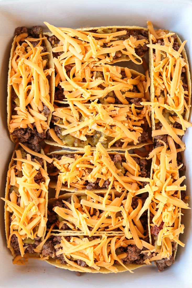 tacos in baking dish topped with cheese