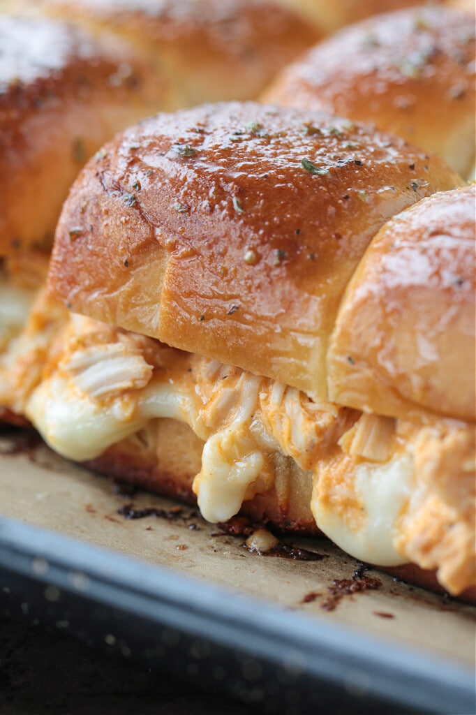 buffalo chicken sliders on a baking sheet